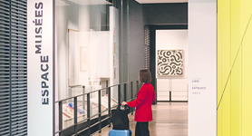Woman with her suitcase walking through the airport museum area