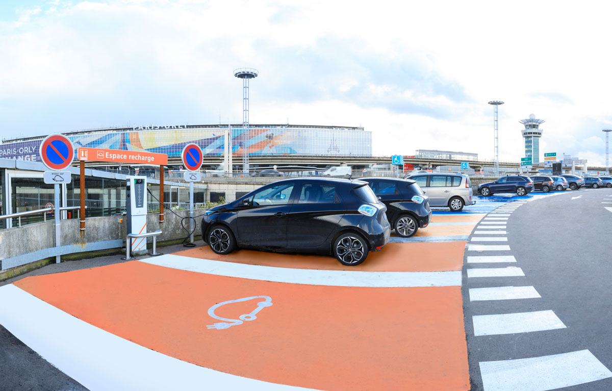 Cars in an official Paris Aeroport parking lot with electric terminals