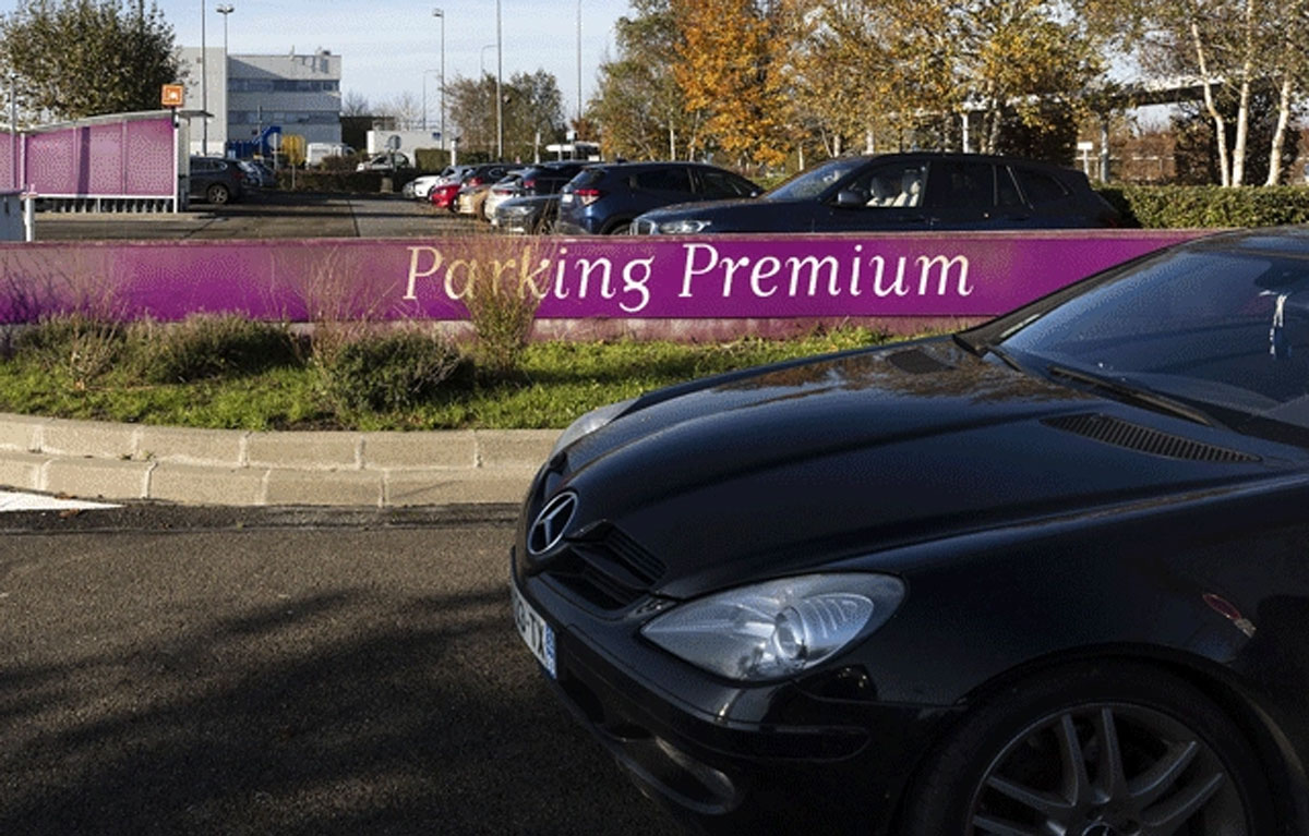 A black car heads for the official Paris Airport premium parking lot